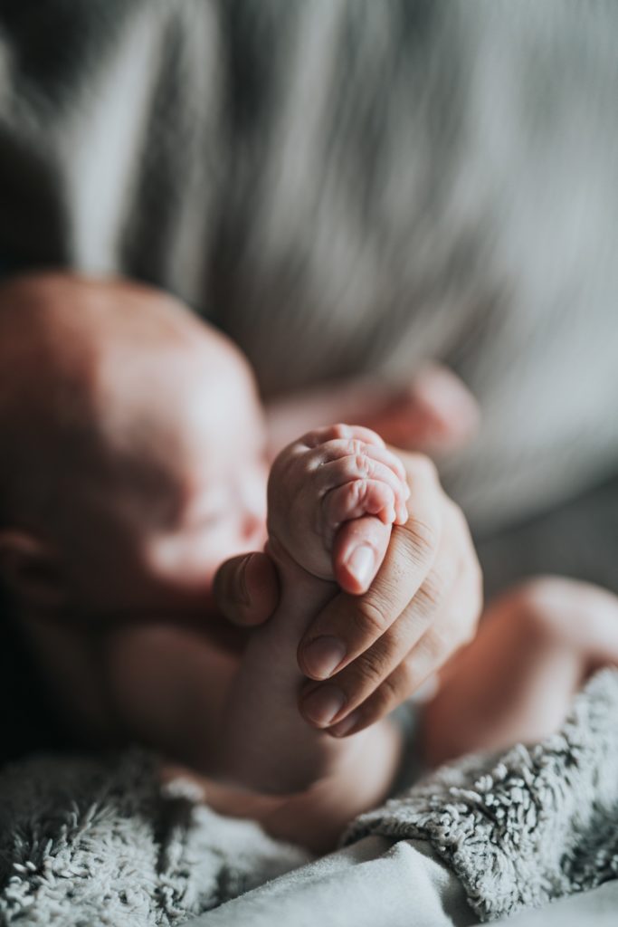 mother keep hand of newborn