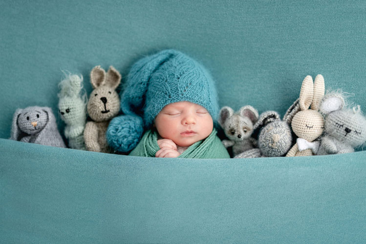 beautiful-newborn-with-knitted-toys